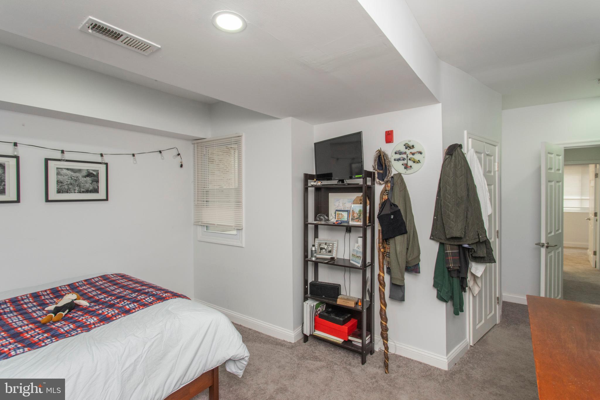 1629 Wallace Street, Unit 1R Philadelphia, PA 19130 - Photo 17 of 22 a bedroom with a bed and a walk in closet