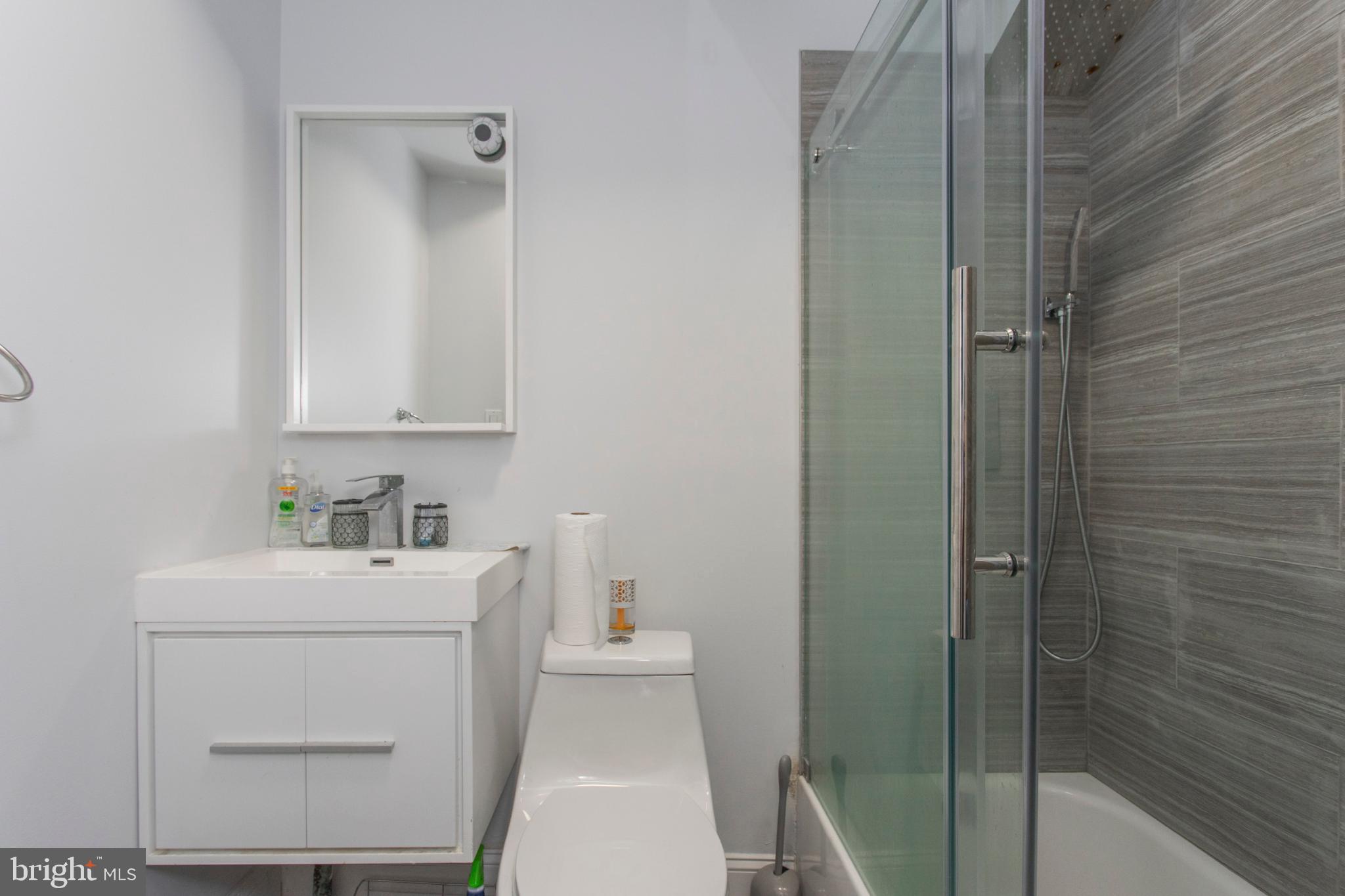 1629 Wallace Street, Unit 1R Philadelphia, PA 19130 - Photo 18 of 22 a bathroom with a sink a toilet and shower