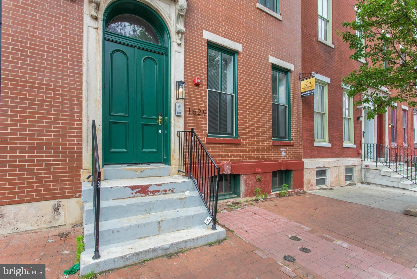 1629 Wallace Street, Unit 1R Philadelphia, PA 19130 - Photo 2 of 22 a front view of a house with a garden