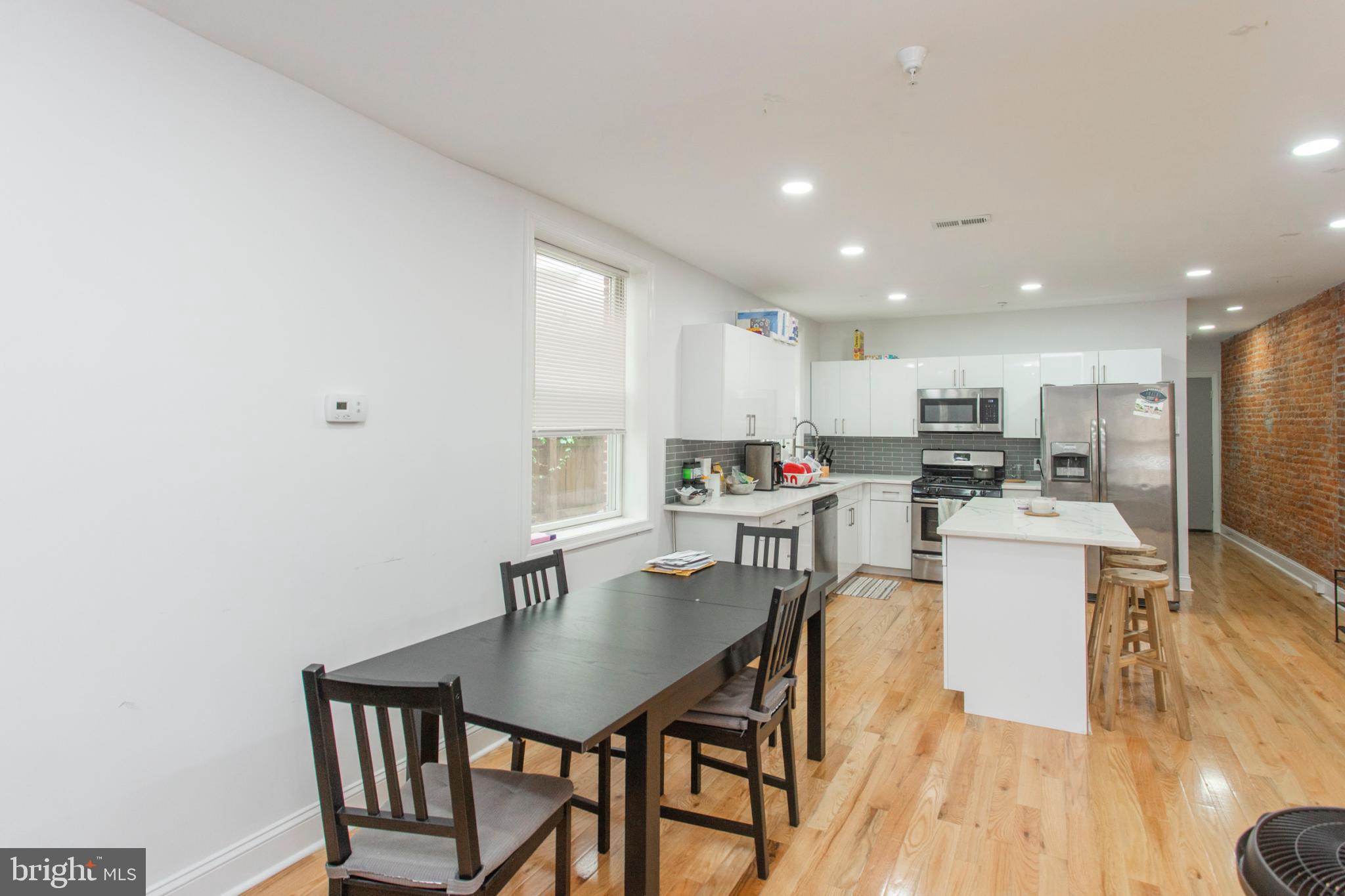 1629 Wallace Street, Unit 1R Philadelphia, PA 19130 - Photo 8 of 22 a kitchen with a table and chairs in it