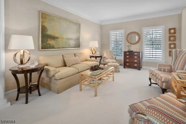 a living room with furniture a large window and a table
