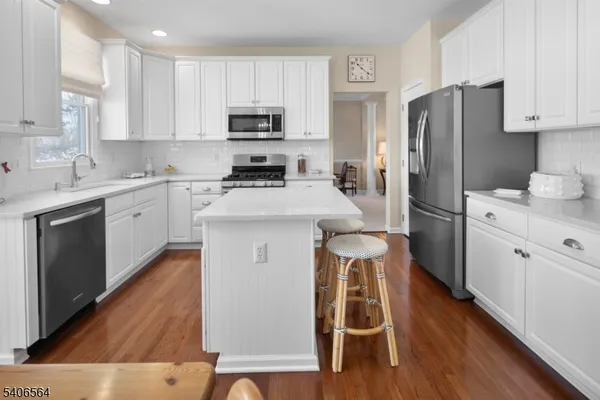 a kitchen with wooden cabinets and stainless steel appliances