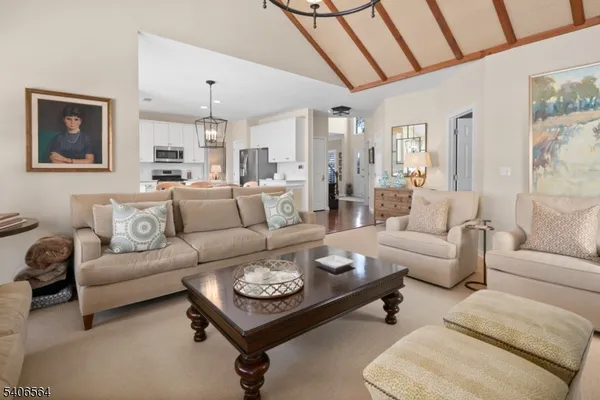 a living room with furniture and a chandelier