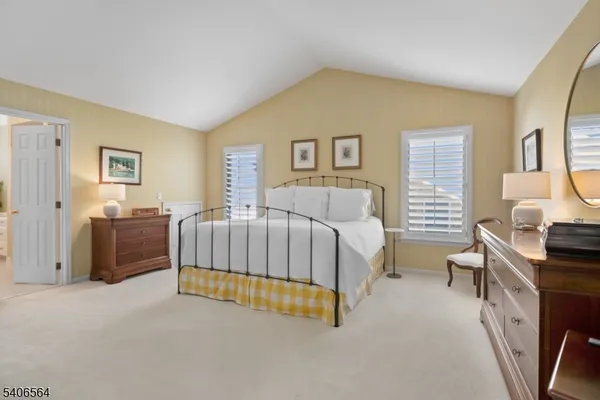 a view of a hallway with closet and a living room