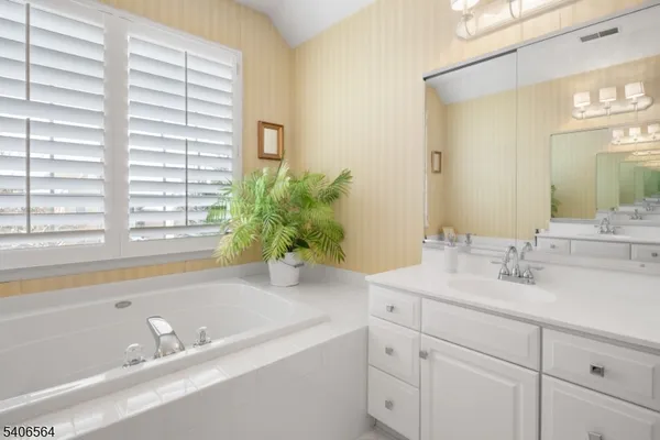 a bedroom with two beds and a window