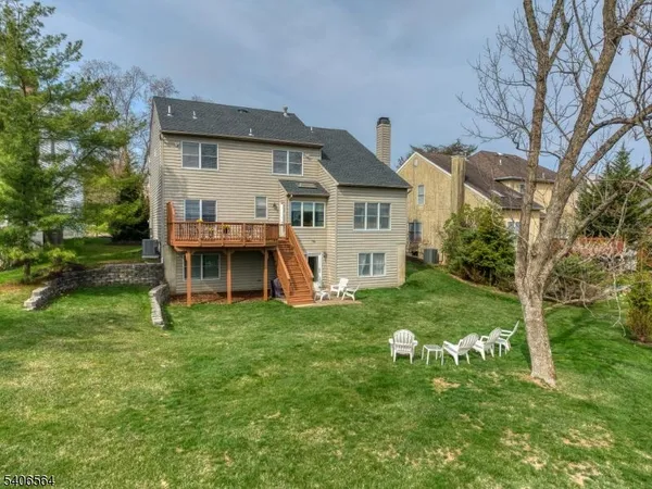 an aerial view of a house with a garden and sitting area