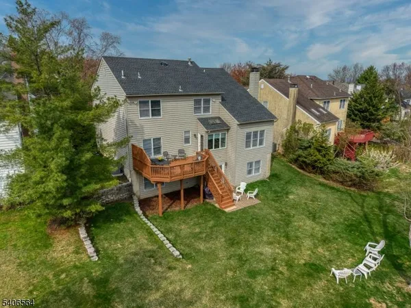 an aerial view of residential houses with outdoor space and trees