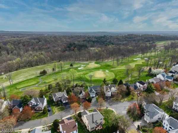 an aerial view of a house with a yard and garden