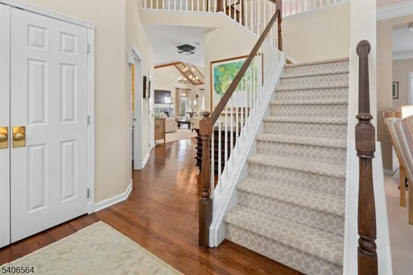 a view of entryway with wooden floor and stairs