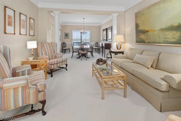 a living room with furniture and a painting on the wall