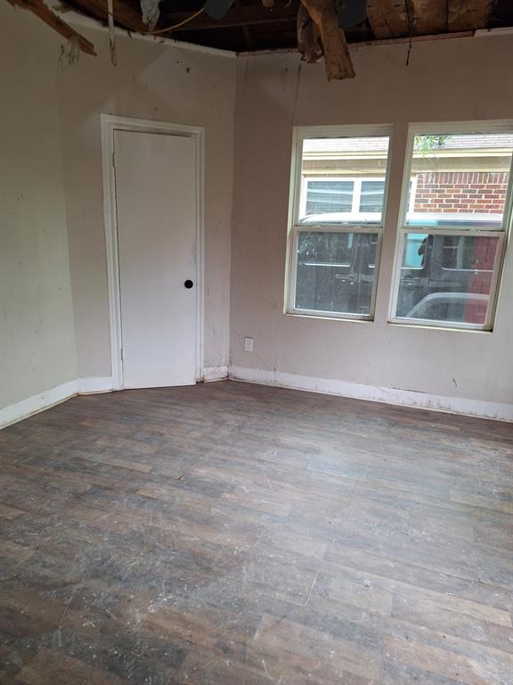 2435 Romine Avenue Dallas, TX 75215 - Photo 12 of 17 Spare room featuring dark wood-type flooring and baseboards