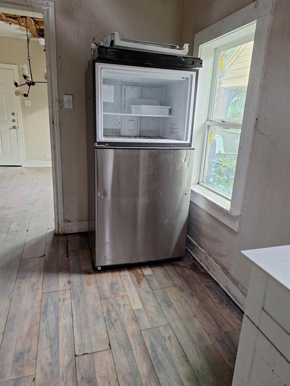 2435 Romine Avenue Dallas, TX 75215 - Photo 14 of 17 Kitchen view of light wood-style floors and freestanding refrigerator