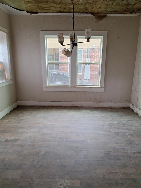 2435 Romine Avenue Dallas, TX 75215 - Photo 17 of 17 Unfurnished dining area featuring a chandelier and baseboards