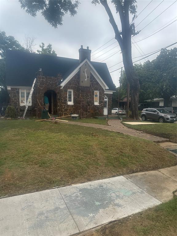 2435 Romine Avenue Dallas, TX 75215 - Photo 2 of 17 View of front facade featuring stone siding, a front yard, and a chimney