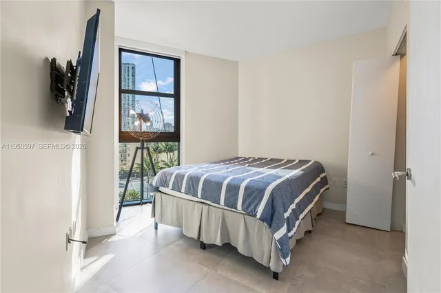 a bed sitting in a bedroom next to a window