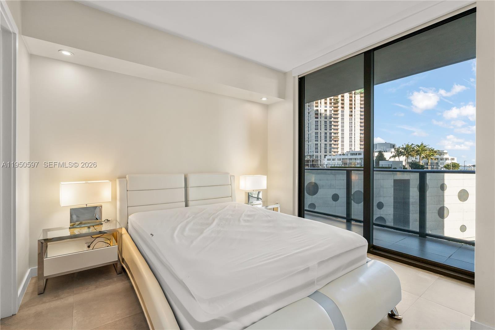 501 Northeast 31st Street, Unit 706 Miami, FL 33137 - Photo 14 of 24 a bedroom with a large bed and a large window