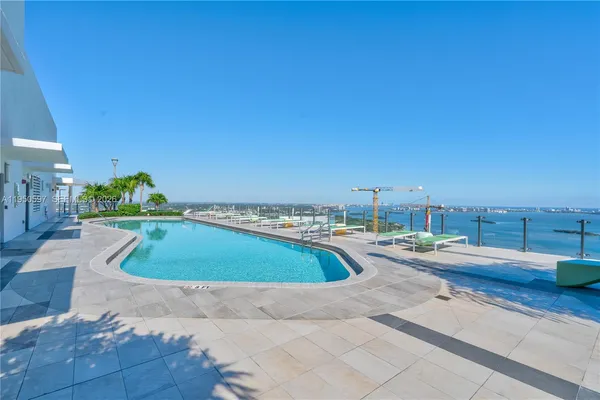 a view of a swimming pool and lounge chair