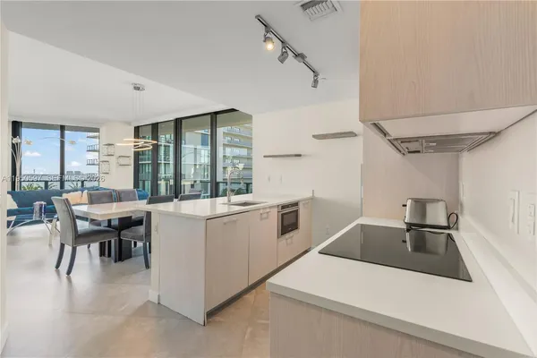 a kitchen that has a sink and a stove in it