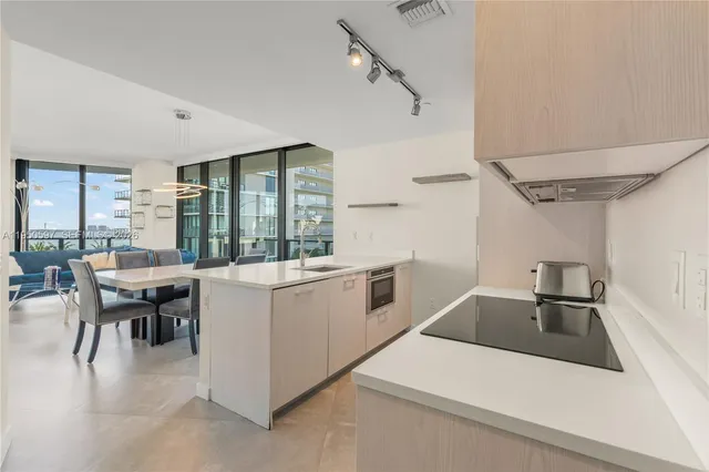 a kitchen that has a sink and a stove in it