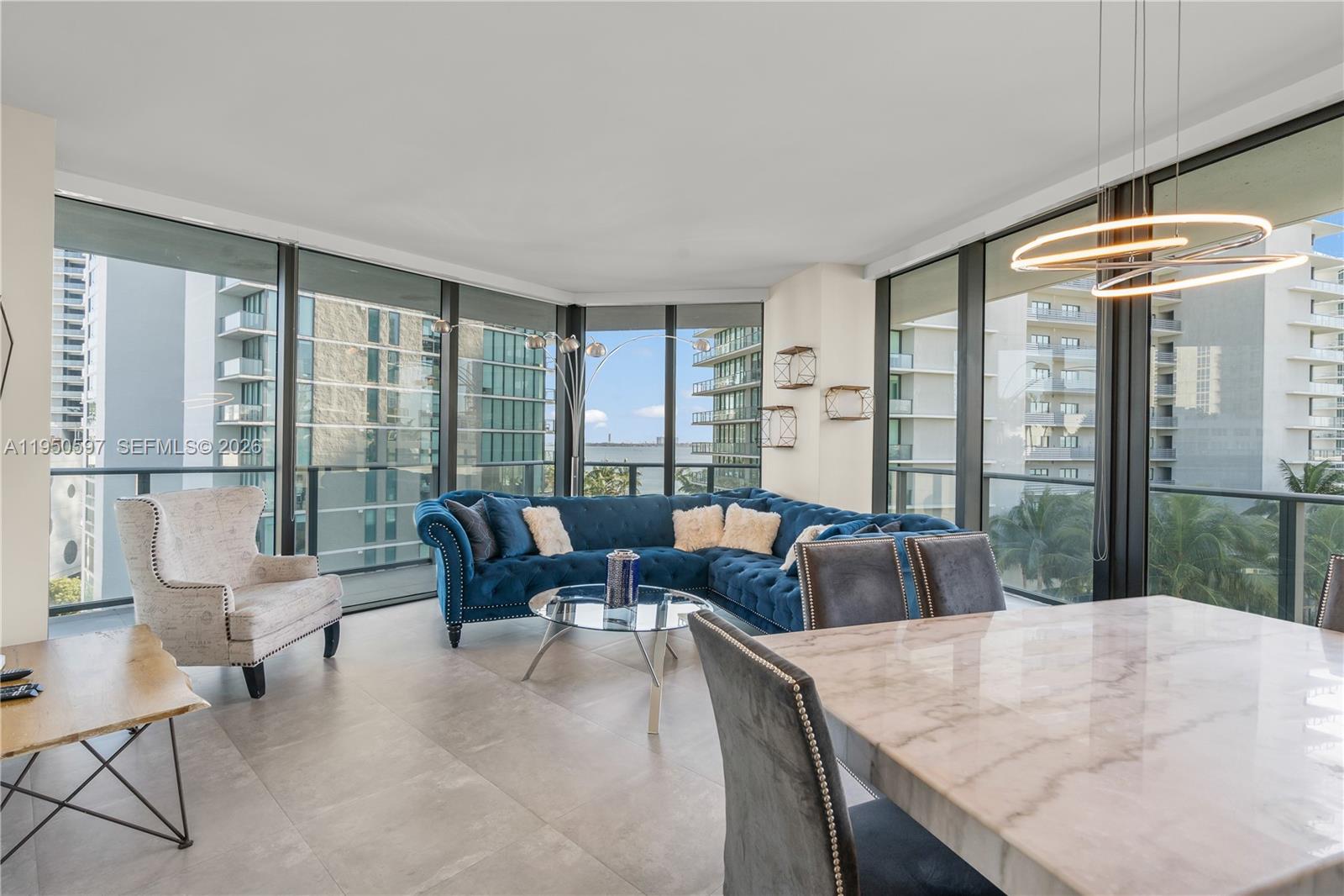 501 Northeast 31st Street, Unit 706 Miami, FL 33137 - Photo 4 of 24 a living room with furniture and a large window