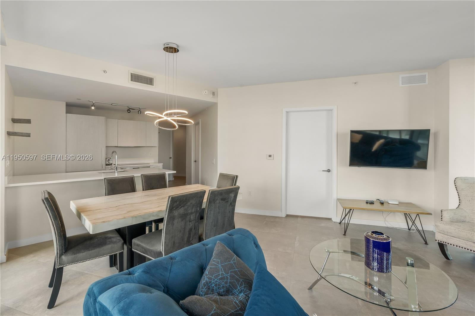 501 Northeast 31st Street, Unit 706 Miami, FL 33137 - Photo 6 of 24 a living room with furniture and a flat screen tv