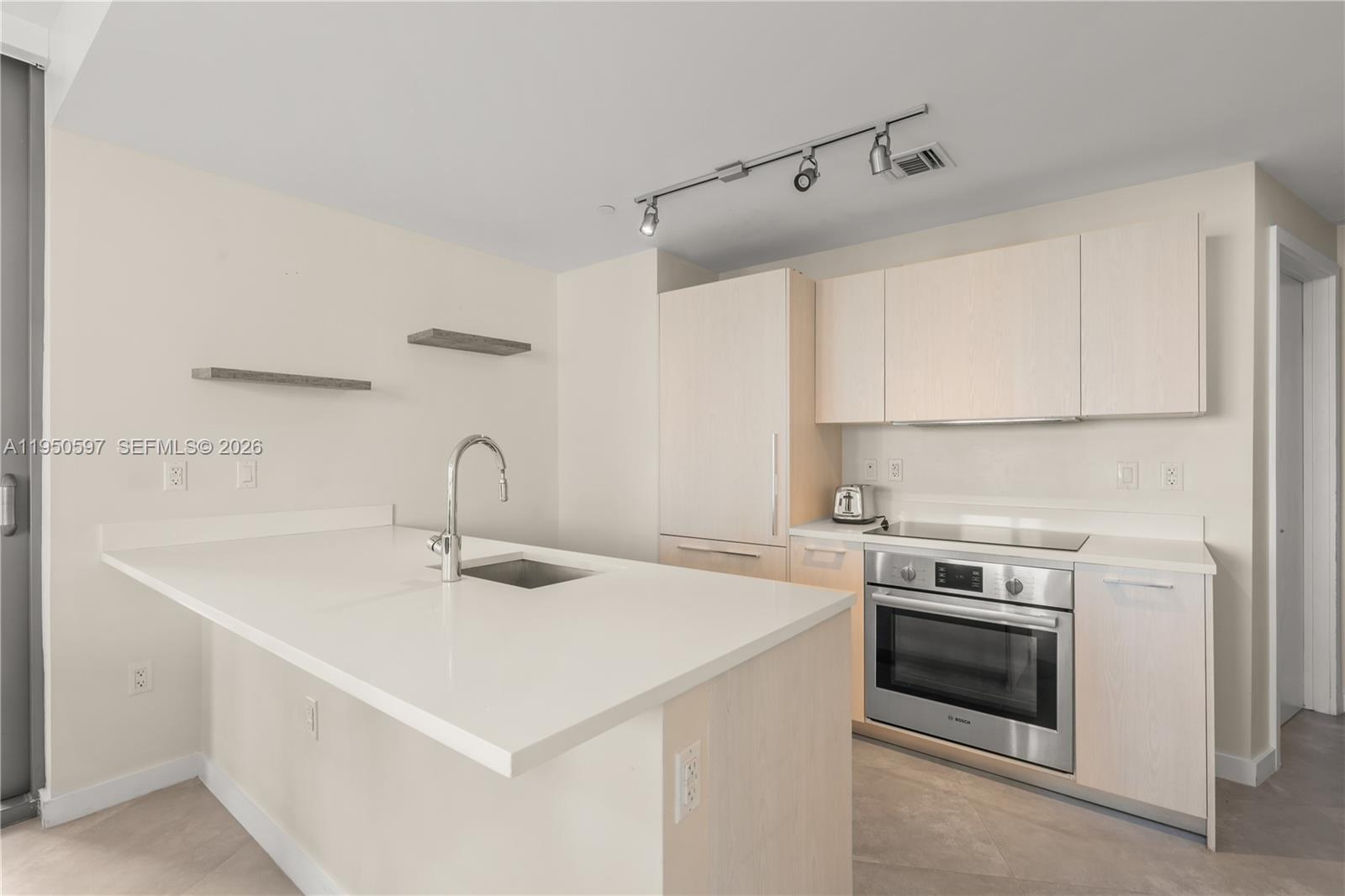 501 Northeast 31st Street, Unit 706 Miami, FL 33137 - Photo 7 of 24 a kitchen with a sink cabinets and appliances