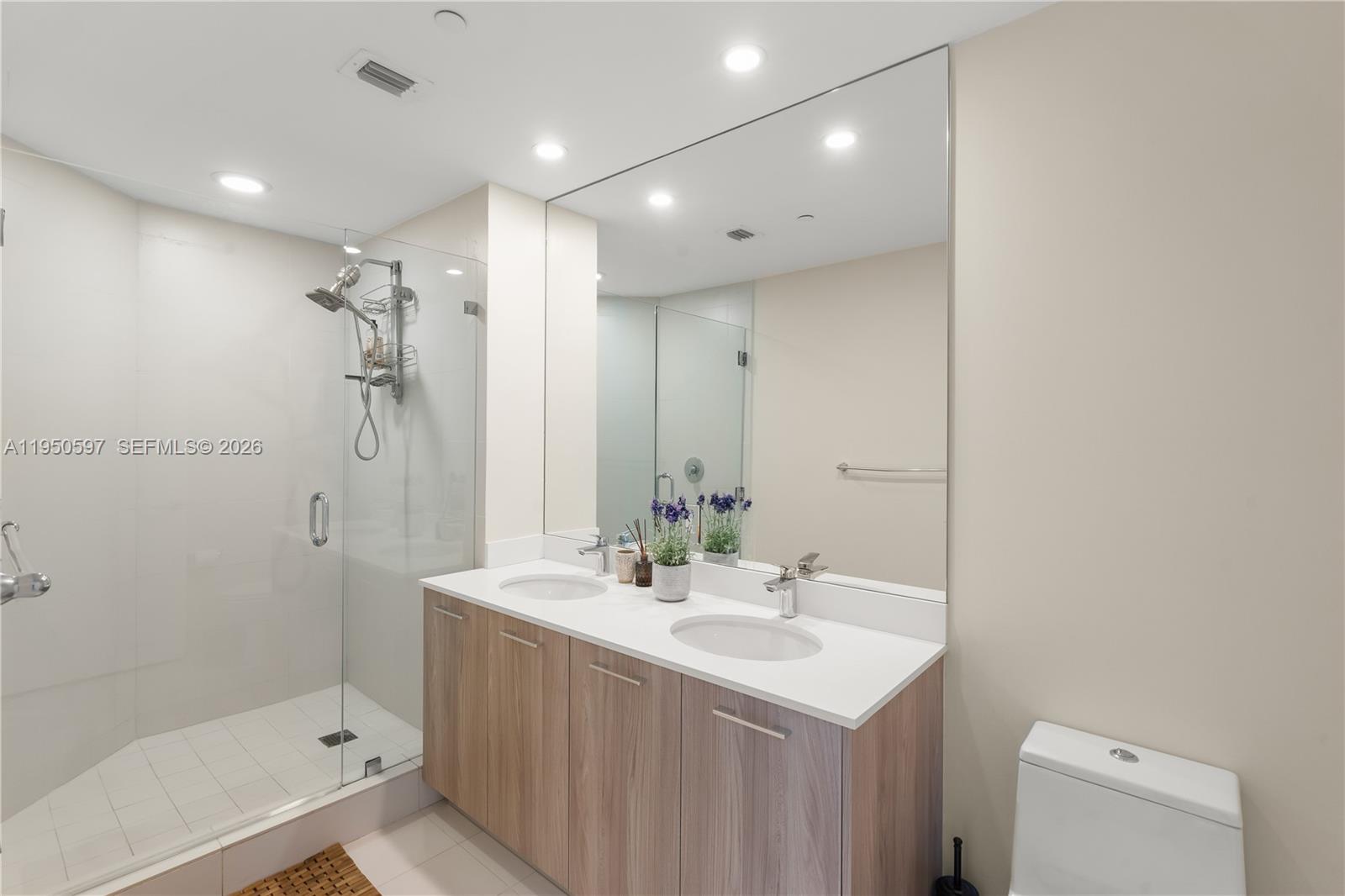 501 Northeast 31st Street, Unit 706 Miami, FL 33137 - Photo 10 of 24 a bathroom with a sink a toilet and shower