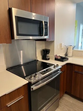 a kitchen with a stove microwave and sink