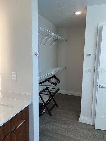 a view of a room with wooden floor and bench