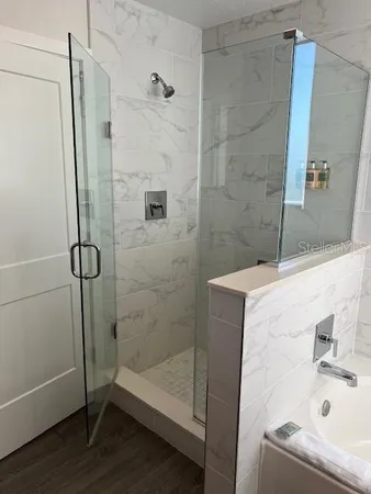 a bathroom with a bathtub and a shower