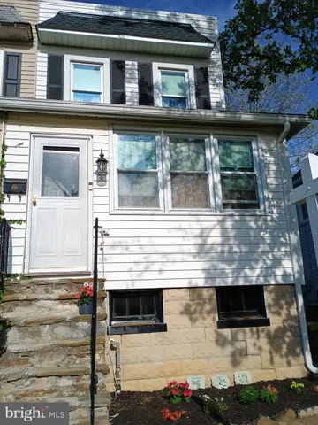 a view of a house with wooden fence