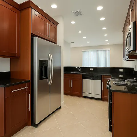 a kitchen with stainless steel appliances granite countertop a refrigerator a sink a stove a microwave and island