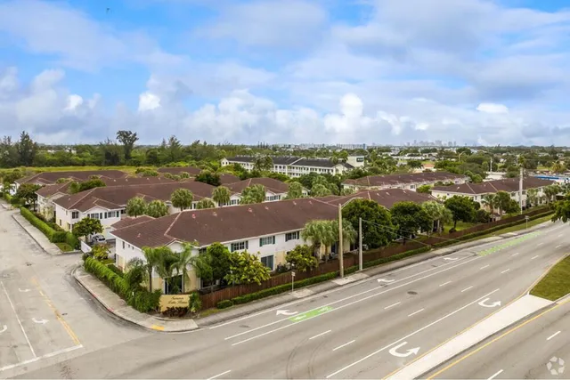 an aerial view of residential houses with outdoor space and street view