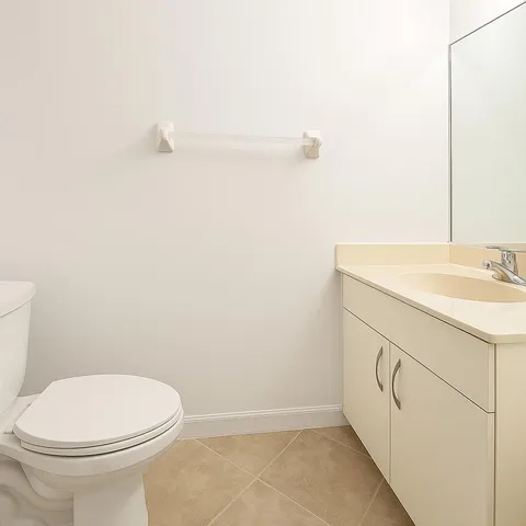 a bathroom with a sink a toilet and mirror