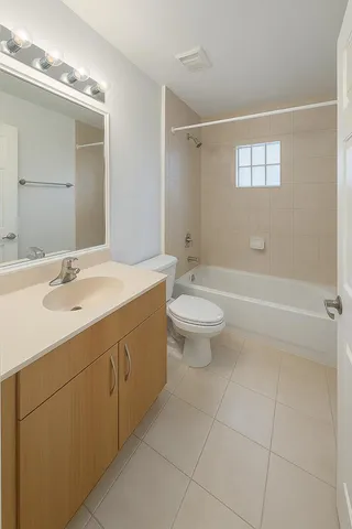 a bathroom with a double vanity sink mirror and toilet