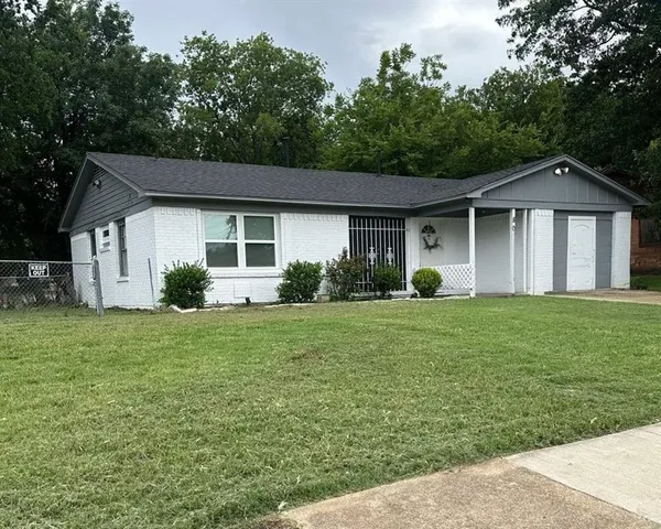 a view of a house with a yard and a garden