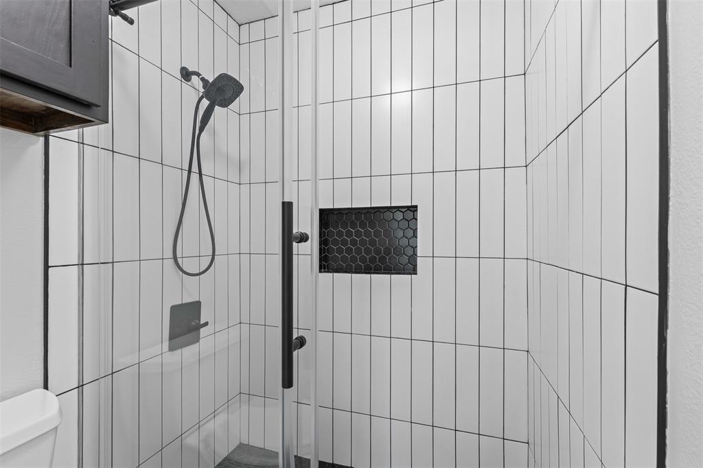 5981 Arapaho Road, Unit 703 Dallas, TX 75248 - Photo 11 of 19 Bathroom with toilet and a shower stall