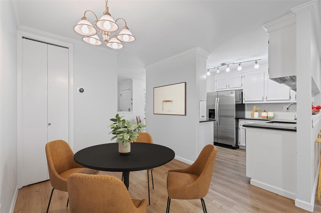 5981 Arapaho Road, Unit 703 Dallas, TX 75248 - Photo 8 of 19 Dining room featuring a chandelier, light wood-type flooring, and ornamental molding