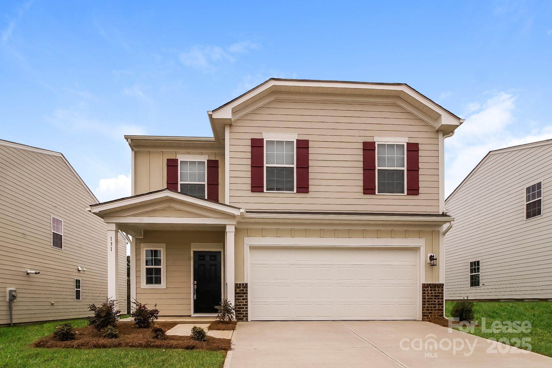 131 Arden Court Troutman, NC 28166 - Photo 1 of 23 a front view of a house with garden
