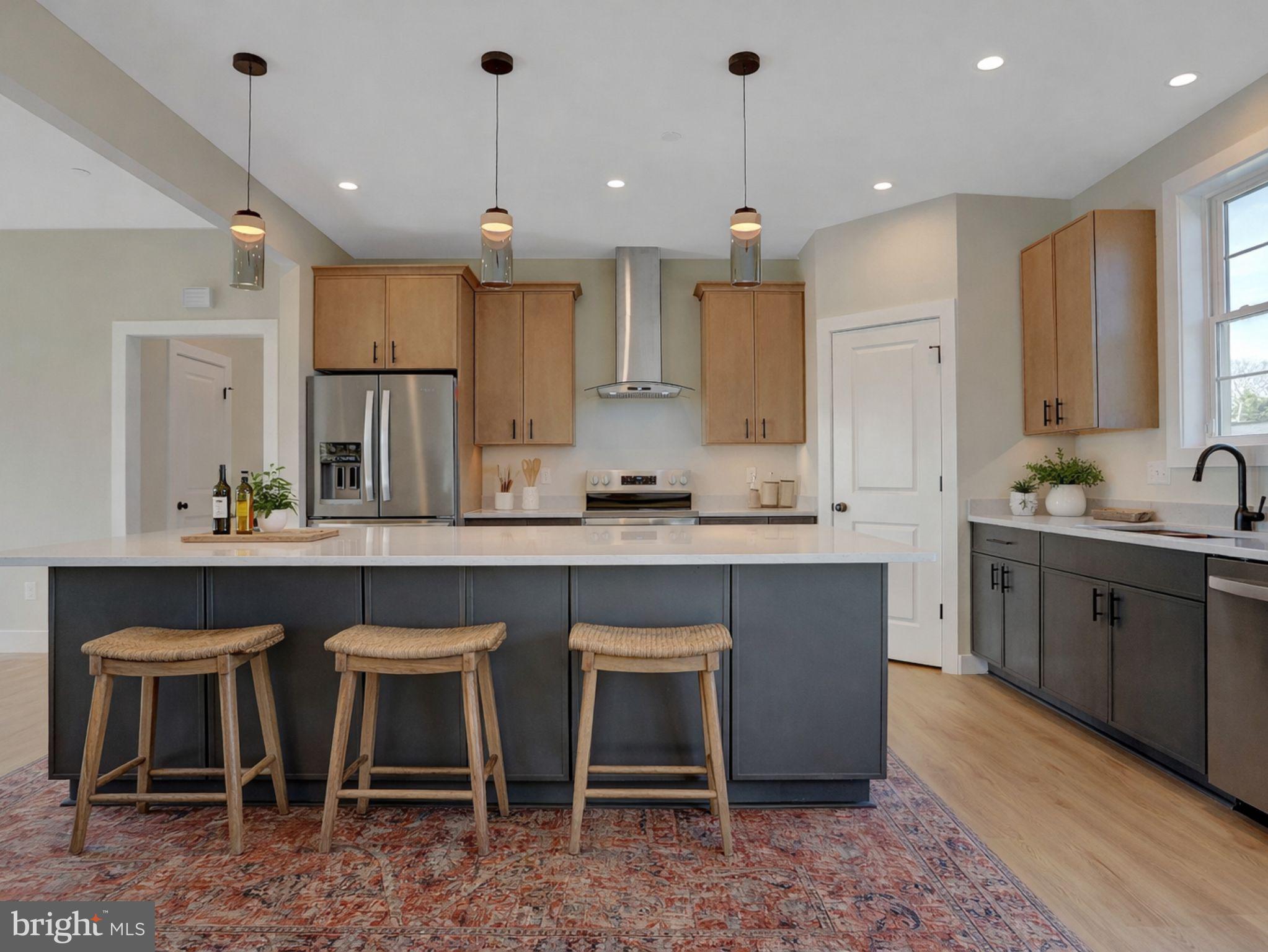 3544 Revolea Beach Road Middle River, MD 21220 - Photo 5 of 28 a kitchen with kitchen island granite countertop a table chairs sink and cabinets