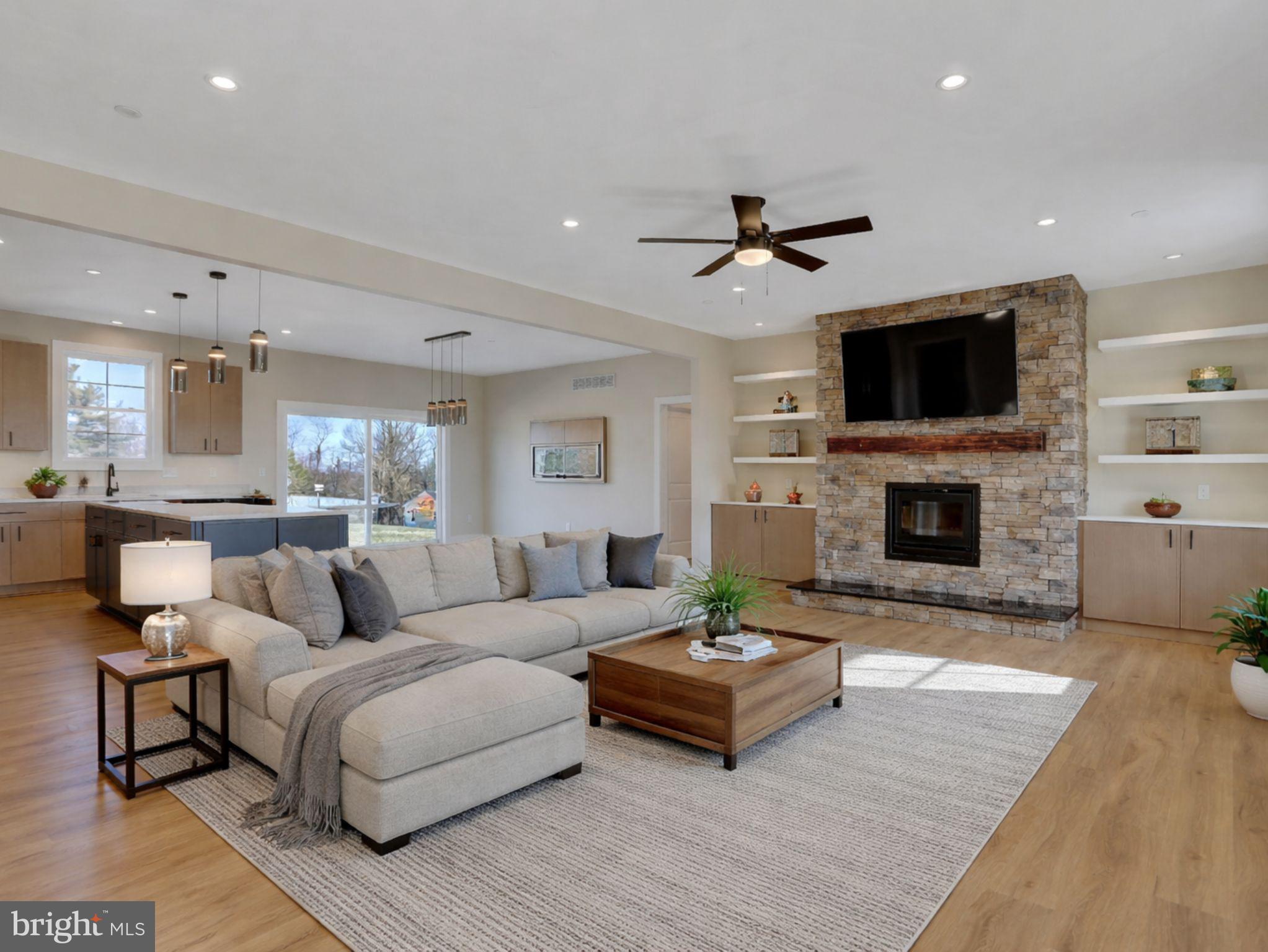 3544 Revolea Beach Road Middle River, MD 21220 - Photo 6 of 28 a living room with furniture a fireplace and a flat screen tv