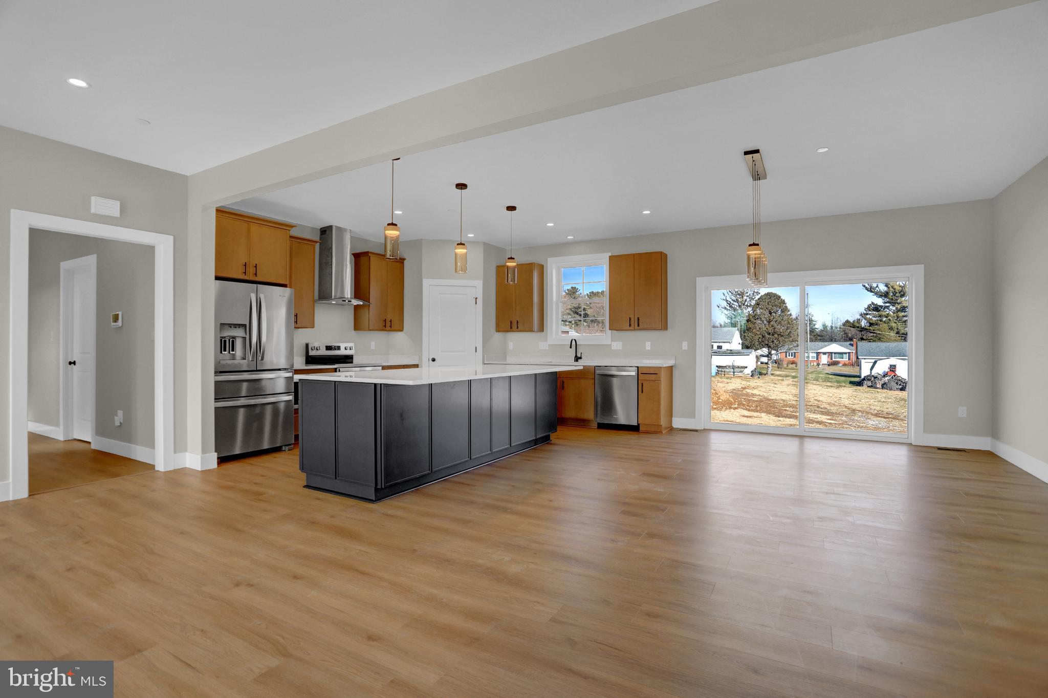 3544 Revolea Beach Road Middle River, MD 21220 - Photo 9 of 28 a view of kitchen with kitchen island wooden floor and refrigerator
