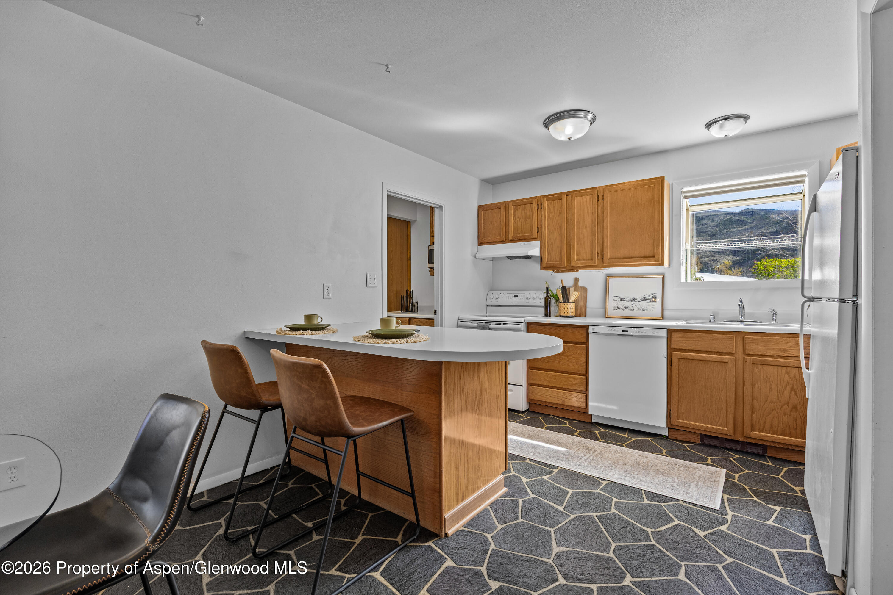 128 Hopi Carbondale, CO 81623 - Photo 13 of 34 a kitchen with a sink cabinets and window