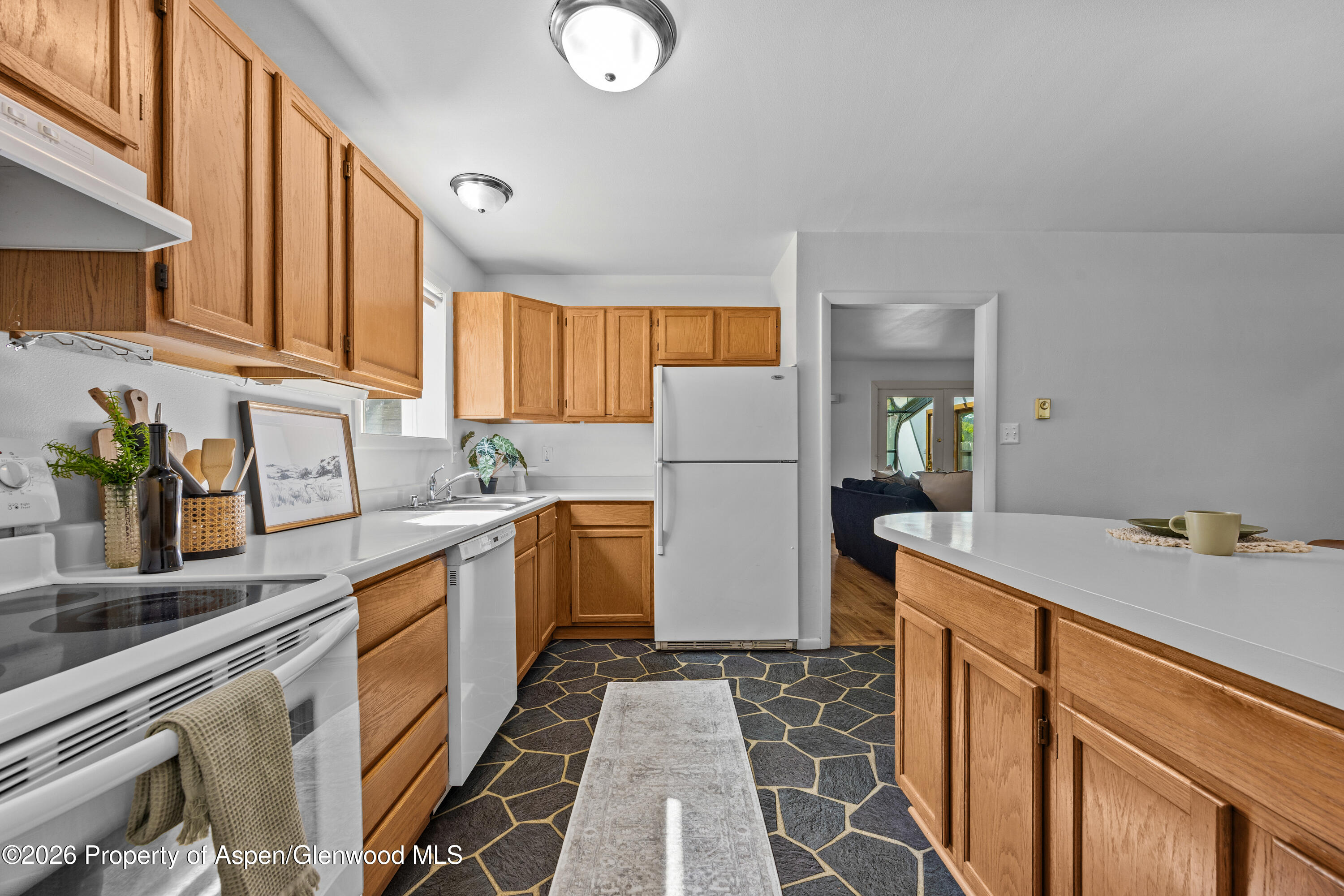 128 Hopi Carbondale, CO 81623 - Photo 14 of 34 a kitchen with a sink a refrigerator and cabinets