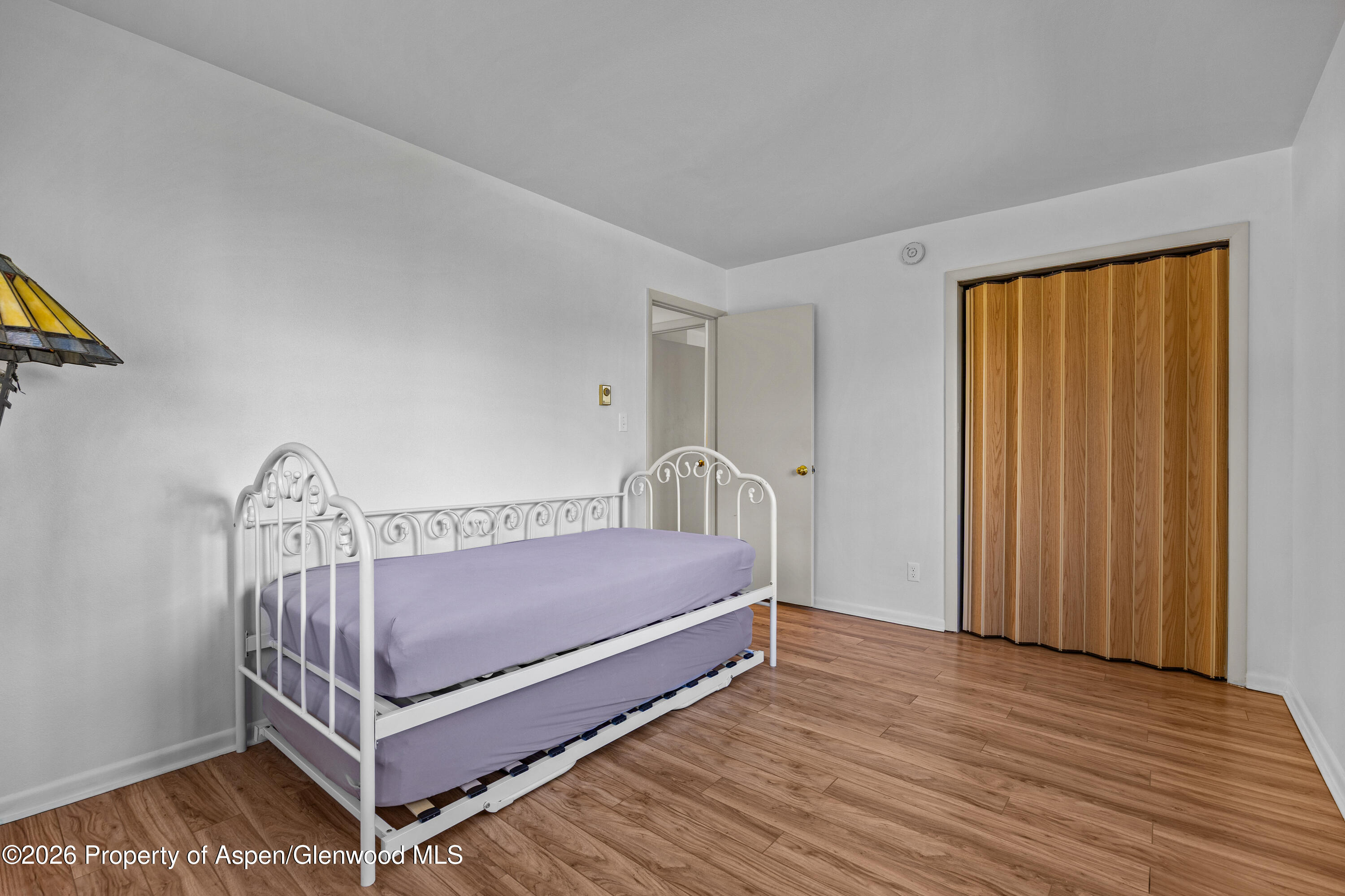 128 Hopi Carbondale, CO 81623 - Photo 20 of 34 a bed sitting in a bedroom next to a window