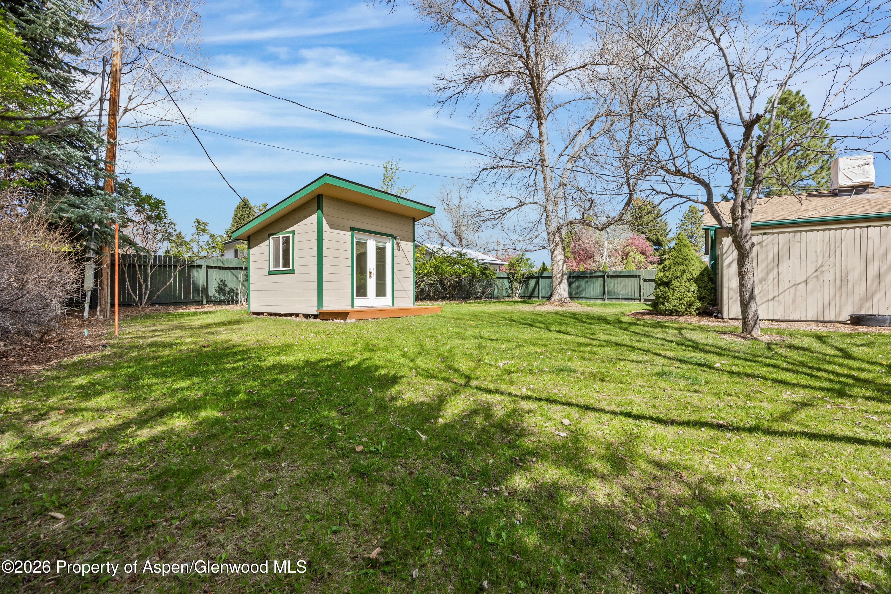 128 Hopi Carbondale, CO 81623 - Photo 27 of 34 a white house that has a big yard with large trees
