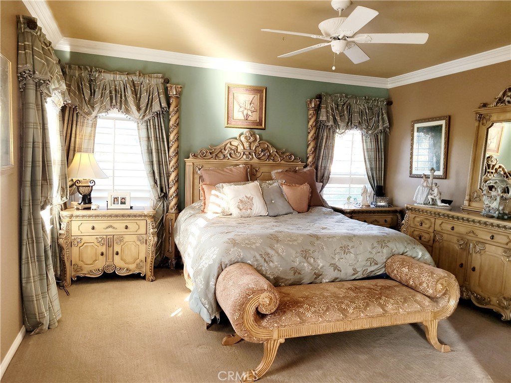14119 Ashton Lane Riverside, CA 92508 - Photo 39 of 47 a spacious bedroom with a bed and a chandelier