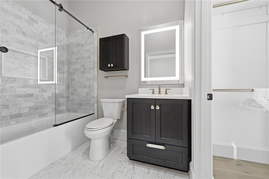 5133 Fifth Avenue Pittsburgh, PA 15232 - Photo 34 of 43 a bathroom with a toilet sink and mirror
