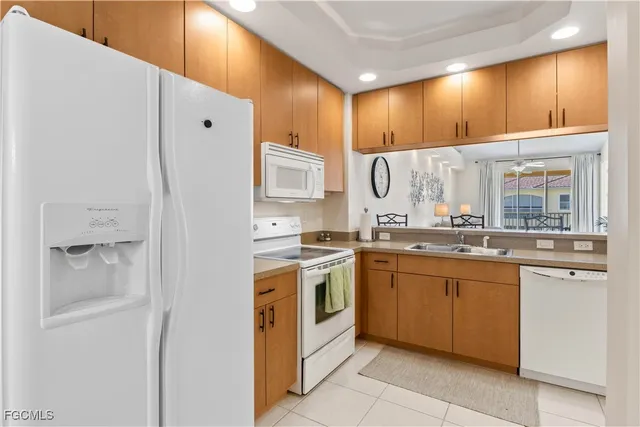 a view of a dining room with furniture a chandelier and wooden floor