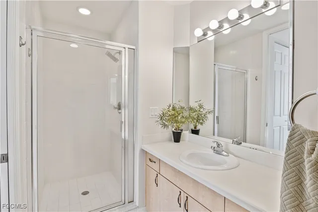 a bedroom with two beds and a chandelier